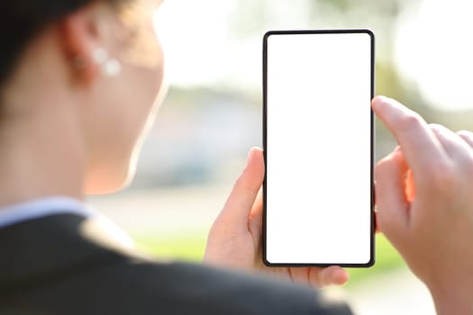 Back view close up of an executive using phone showing blank screen