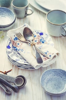 Sustainability concept - stoneware and kitchenware on wooden kitchen table