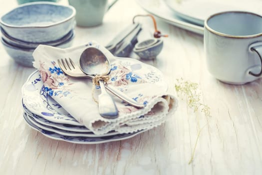Sustainability concept - stoneware and kitchenware on wooden kitchen table