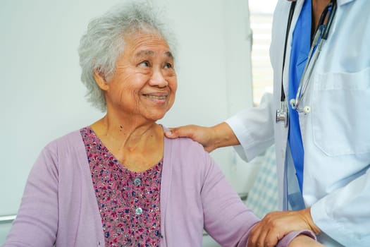 Doctor help Asian elderly woman disability patient walk with walker in nursing hospital, medical concept.
