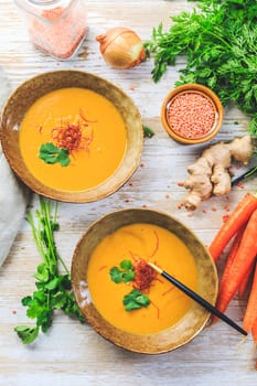 Homemade red lentil soup with carrots, ginger and coconut milk with ingredients