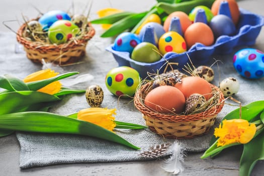 Spring time - Easter eggs and tulips on grey background