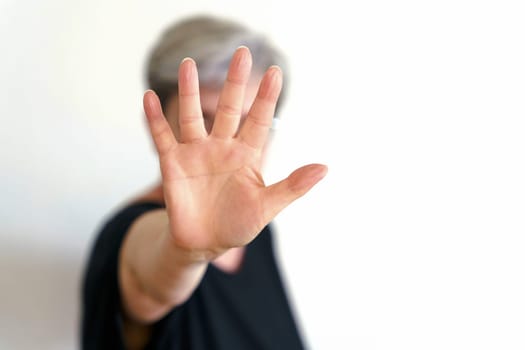 A woman protects herself with defensive hand movement