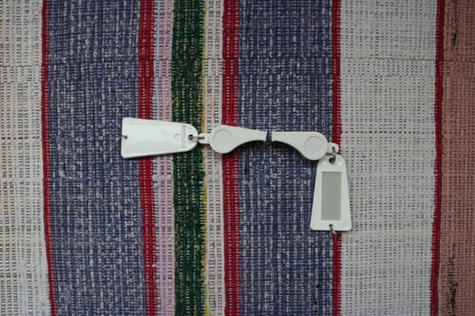 two white sports whistle, signal, fan, with a tag still life
