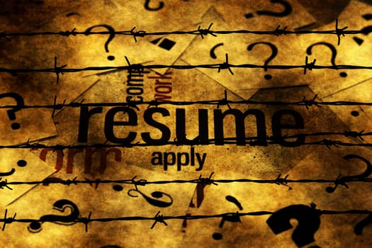 Resume and question marks against barbwire