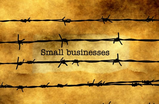 Small business concept against barbwire