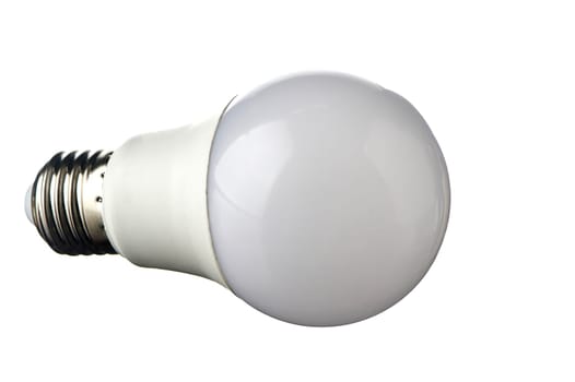 A white LED lamp with an E27 base lies on a white insulated background. High quality photo