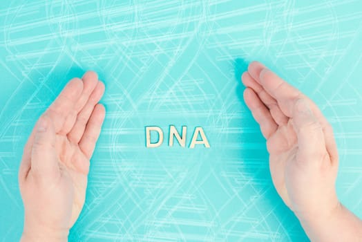 the word DNA is standing between the hands, genetic therapy and treatment, biotechnology in mordern medicine, health care