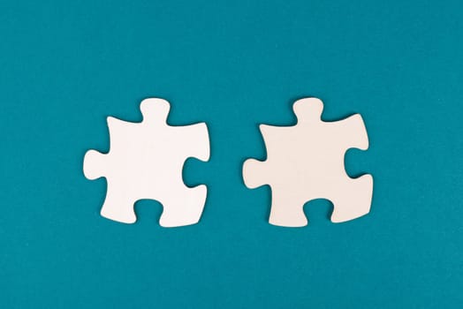 Two pieces of a puzzle, connecting together as a team, solving a problem, strategy and communication concept