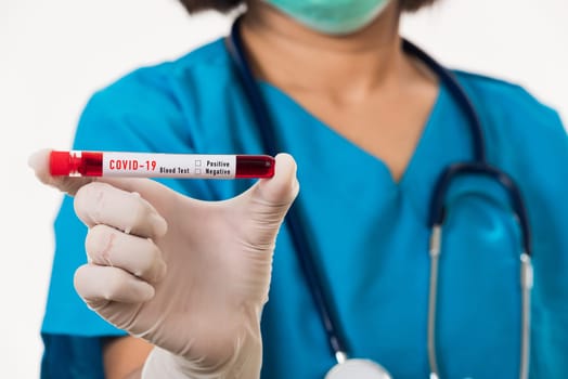 Nurse in blue uniform wear a mask holding test tube sample Coronavirus test blood in the laboratory for analyzing isolated on white background, medicine COVID-19 pandemic outbreak concept