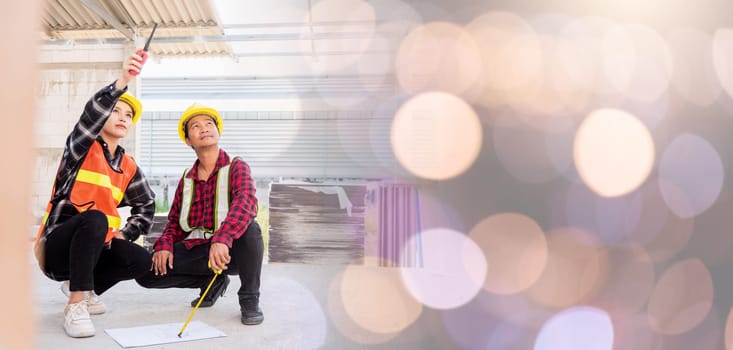 Architect and client discussing help create plan with blueprint of the building at construction site. Asian engineer foreman worker man and woman meeting talking on drawing paper project, team work