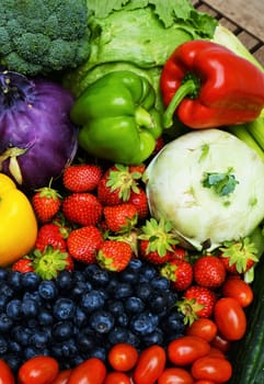 Fresh healthy fruits and vegetables on a wooden table