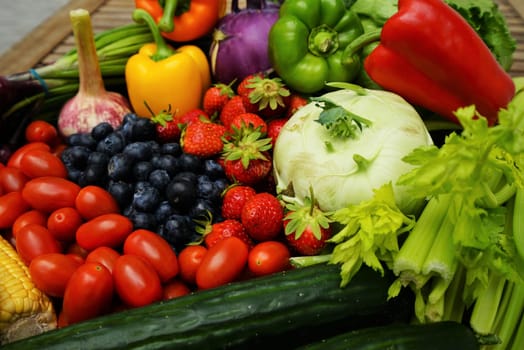 Fresh healthy fruits and vegetables on a wooden table