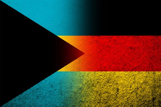 The national flag of Germany with Bahamas national flag. Grunge background