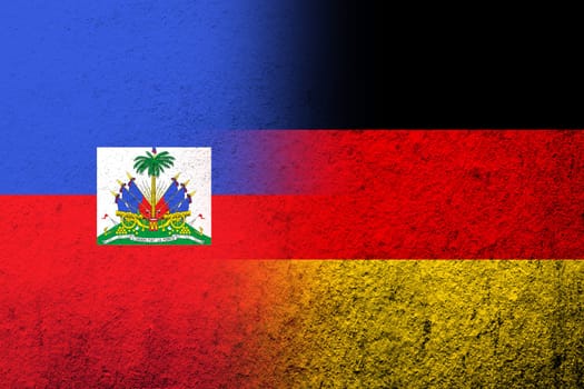 The national flag of Germany with Haiti National flag. Grunge background