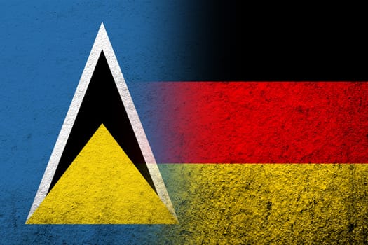The national flag of Germany with National flag of Saint Lucia. Grunge background