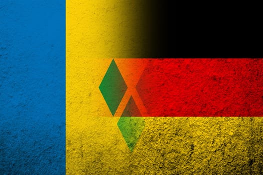 The national flag of Germany with National flag of Saint Vincent and the Grenadines. Grunge background