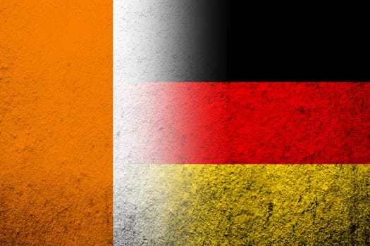 The national flag of Germany with Ivory Coast National flag. Grunge background