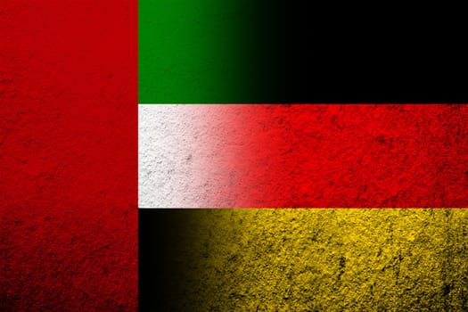 The national flag of Germany with National flag of United Arab Emirates. Grunge background