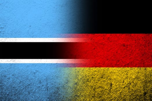 The national flag of Germany with The Republic of Botswana National flag. Grunge background