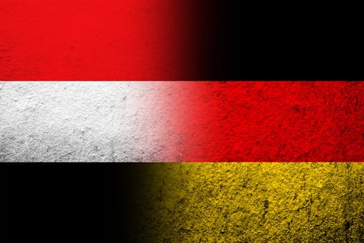 The national flag of Germany with National flag of Yemen. Grunge background