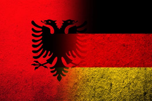 The national flag of Germany with Republic of Albania National flag. Grunge background