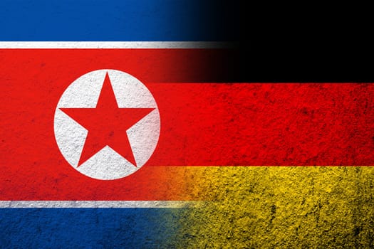 The national flag of Germany with North Korea National flag. Grunge background