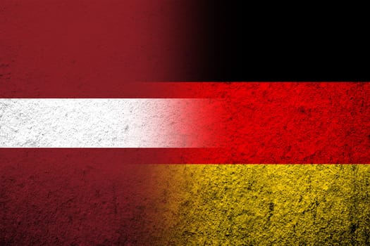 The national flag of Germany with The Republic of Latvia National flag. Grunge background