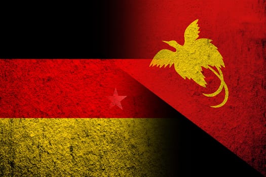 The national flag of Germany with The Independent State of Papua New Guinea National flag. Grunge background