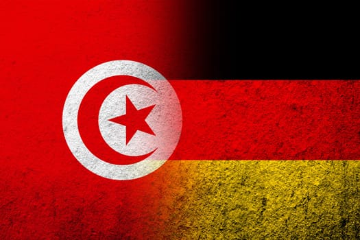 The national flag of Germany with The Republic of Tunisia National flag. Grunge background