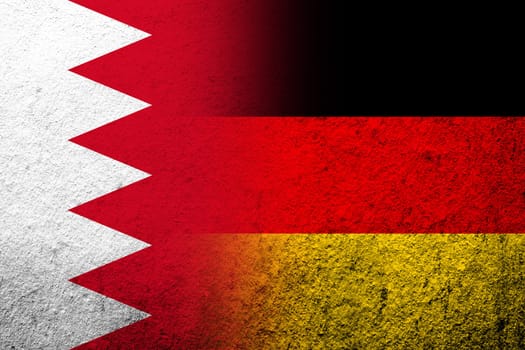 The national flag of Germany with The Kingdom of Bahrain national flag. Grunge background