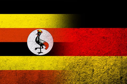 The national flag of Germany with The Republic of Uganda National flag. Grunge background