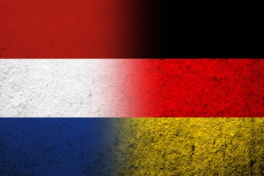 The national flag of Germany with The Kingdom of the Netherlands National flag. Grunge background
