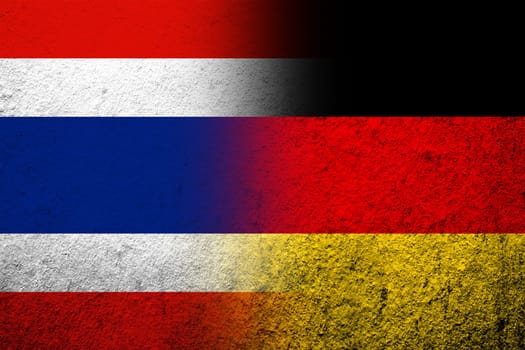 The national flag of Germany with The Kingdom of Thailand National flag. Grunge background