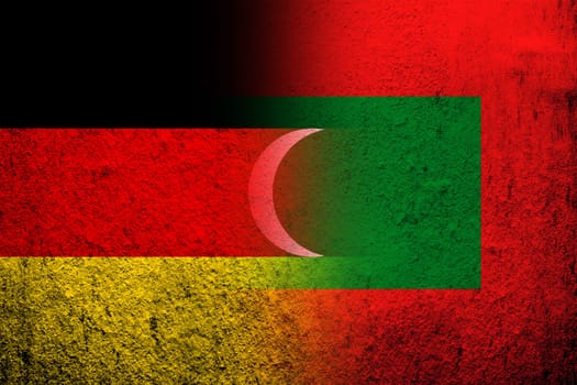 The national flag of Germany with The Republic of Maldives National flag. Grunge background