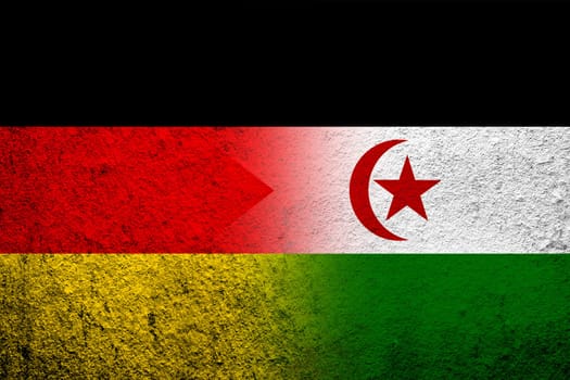 The national flag of Germany with the Sahrawi Arab Democratic Republic Western Sahara national flag. Grunge background
