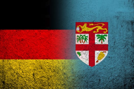 The national flag of Germany with The Republic of Fiji National flag. Grunge background