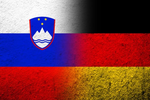 The national flag of Germany with The Republic of Slovenia National flag. Grunge background