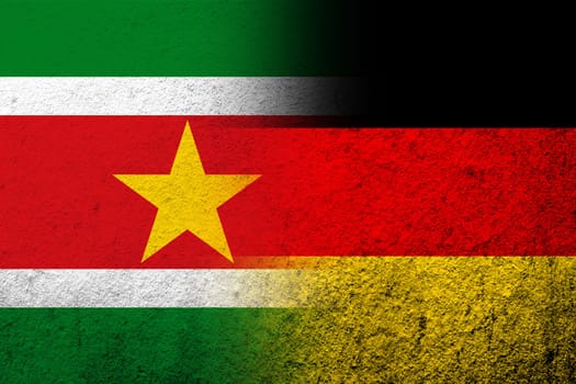 The national flag of Germany with The Republic of Suriname National flag. Grunge background