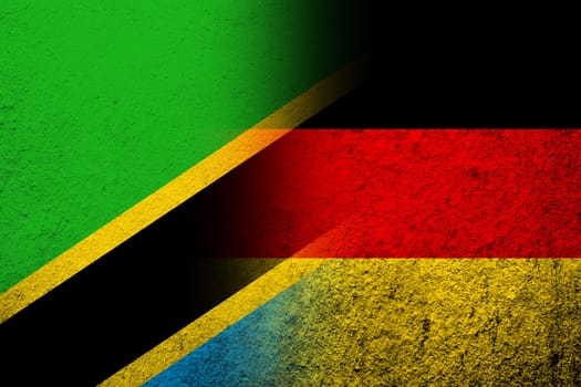 The national flag of Germany with The United Republic of Tanzania National flag. Grunge background