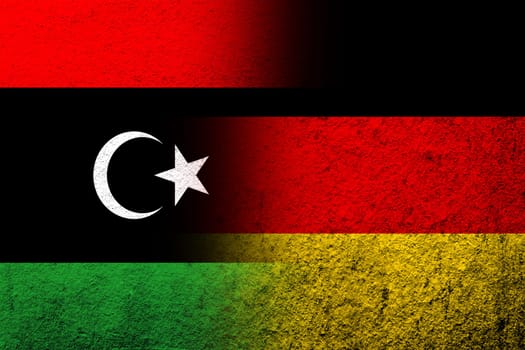 The national flag of Germany with The State of Libya National flag. Grunge background