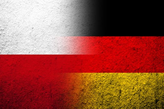 The national flag of Germany with The Republic of Poland national flag. Grunge background