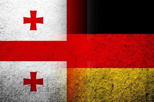 The national flag of Germany with The national flag of the country of Georgia. Grunge background