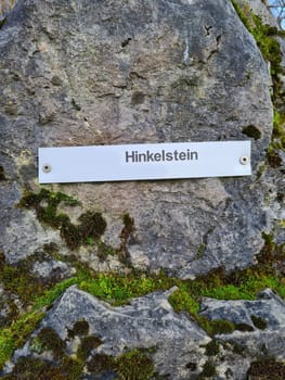 Menhir megalithic stone in Velbert Germany with inscription in Deutsch- Hinkelstein. Large megalithic stone, as a field archaeological monument.