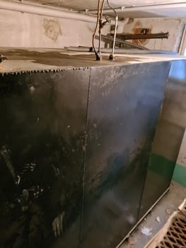Old heating oil tank in dingy dank basement.