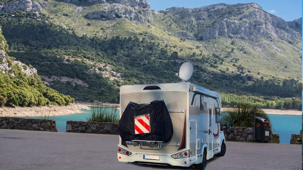 Motorhome campervan parked in a parking lot in Mallorca with the freshwater reservoirs, Embalse de Cúber and the Gorg Blau in the background