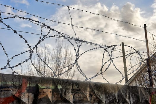 Barbed wire on a blue sky background. High quality photo