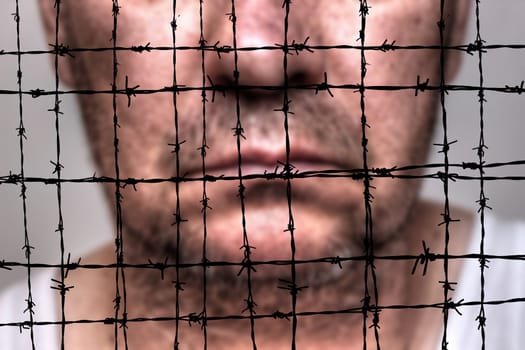 Prisoner against barbwire