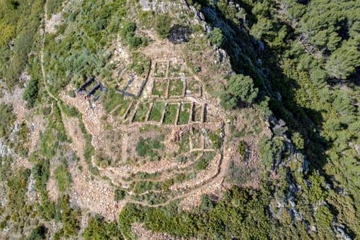 Tossal del Mortorum is an archaeological site located on a hill facing the coastal plain of Ribera de Cabanes, Castellon Spain aerial overhead view