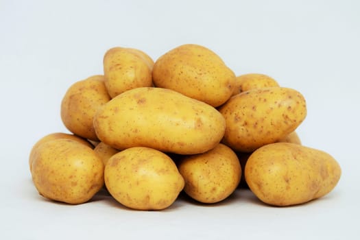 Fresh organic potatoes on white background